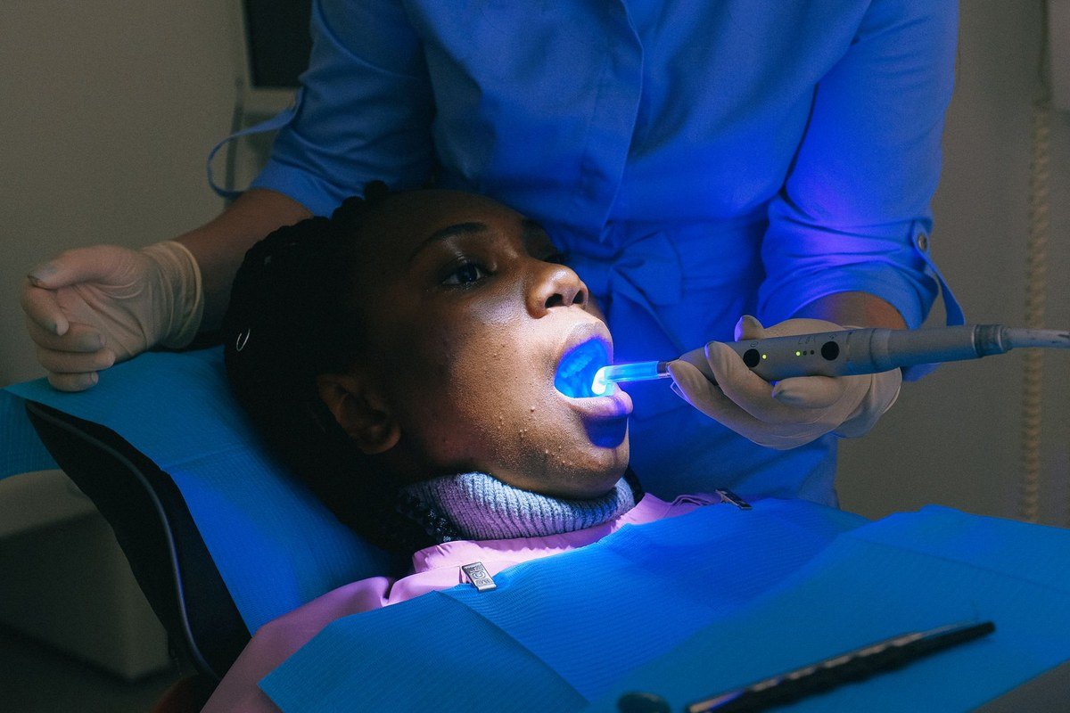 Dentist light-curing a tooth-coloured composite filling at The Port Dental Clinic in Calgary NE