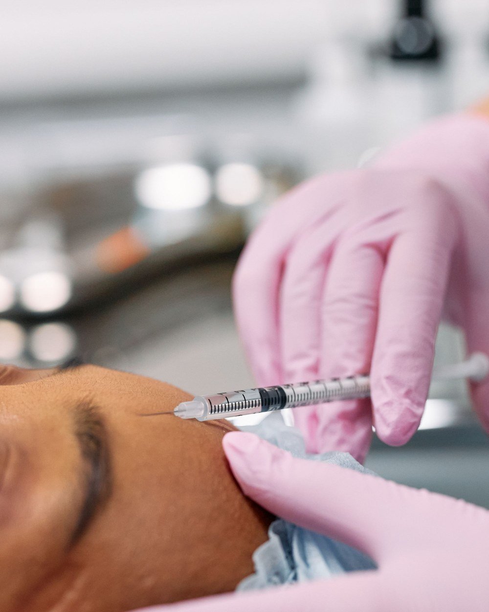Clinician administering a precise facial aesthetic injection to a relaxed patient at The Port Dental Clinic in Calgary NE