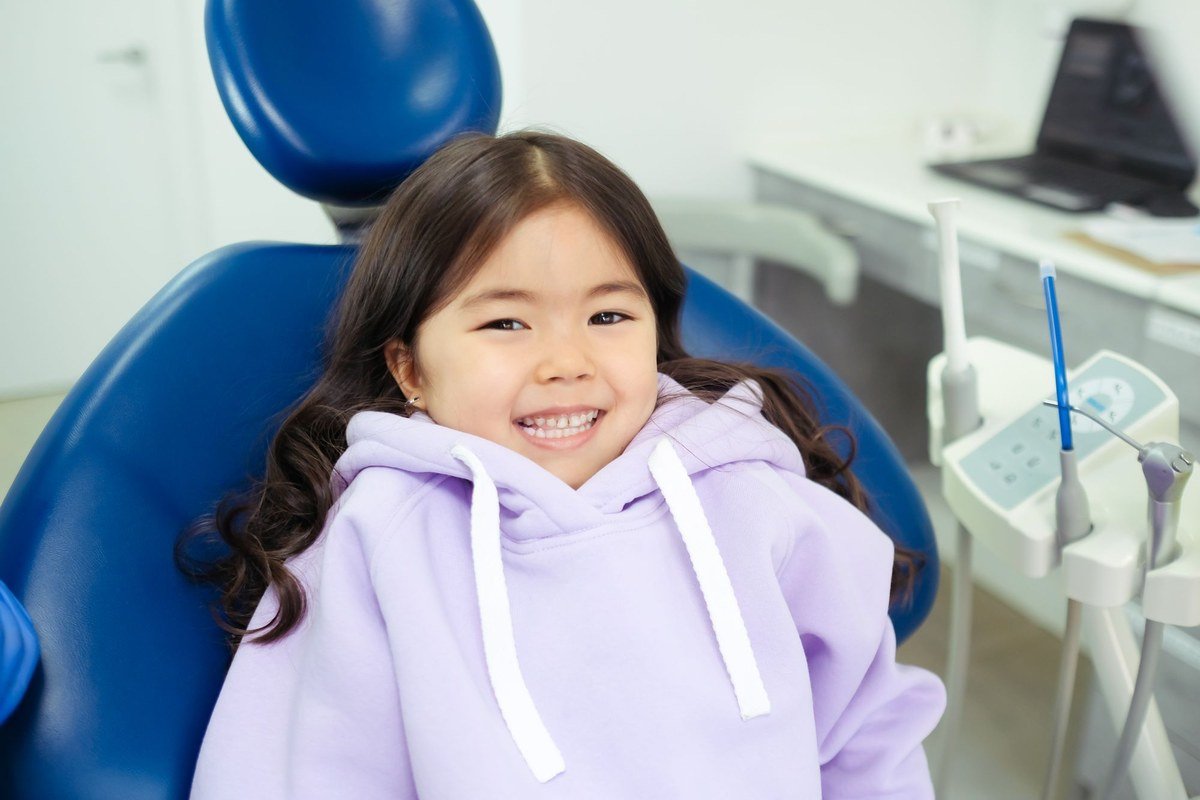 Happy young child smiling in the dental chair at The Port Dental Clinic kids dentistry in Calgary NE