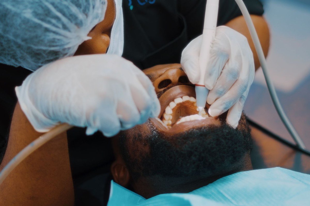 Ultrasonic scaling to remove plaque and tartar during a professional teeth cleaning at The Port Dental Clinic in Calgary NE