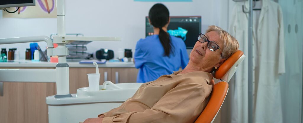 Senior woman looking on camera waiting on dental clinic