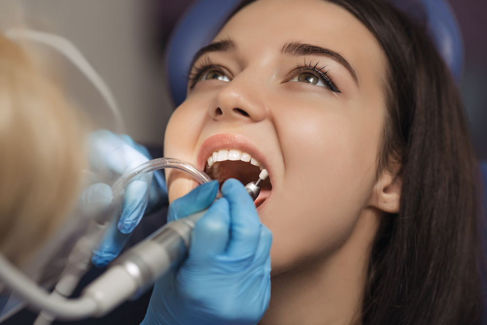 Who are dental hygienists, and what role do they play in treatments?