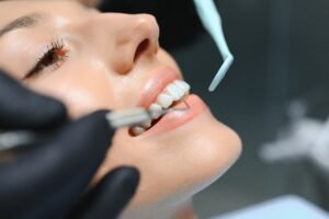 Doctor examining patient's teeth, closeup. Cosmetic dentistry
