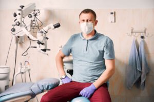 Handsome male dentist giving thumbs up.