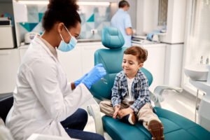 little-boy-talking-to-african-american-female-dentist