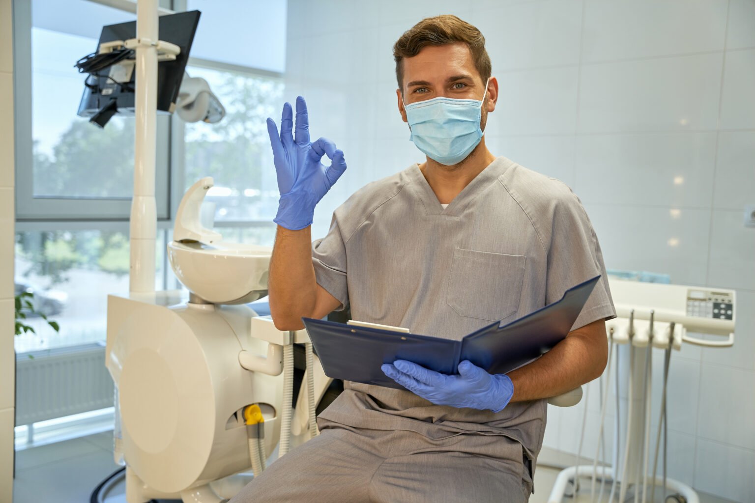 Joyful worker of dental clinic practising positive atittude