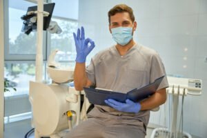 Joyful worker of dental clinic practising positive atittude