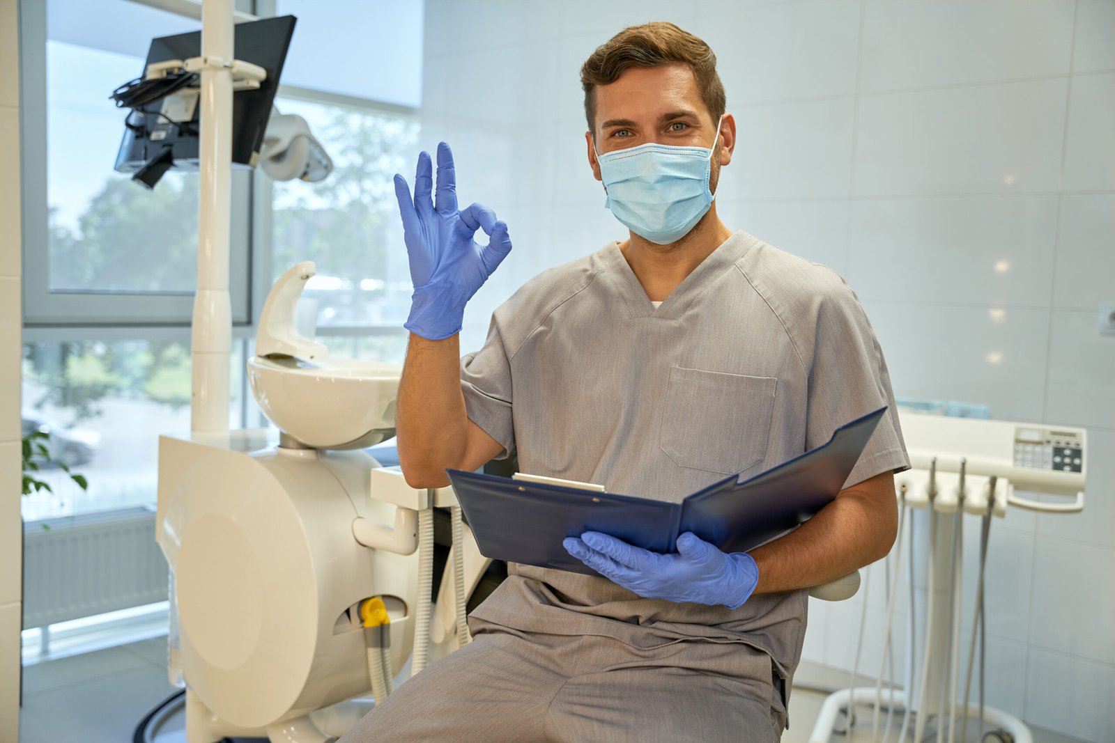 Joyful worker of dental clinic practising positive atittude